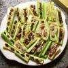 This dish is commonly called "Ants on a log" and is a popular hors doeuvre served at kids parties. Commonly made with Celery, Peanut butter, Tahini, Cashew butter, Almonds and Raisings to represent Ants.