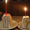Two traditional Russian curd paskhas, with kulichs and easter eggs in the background